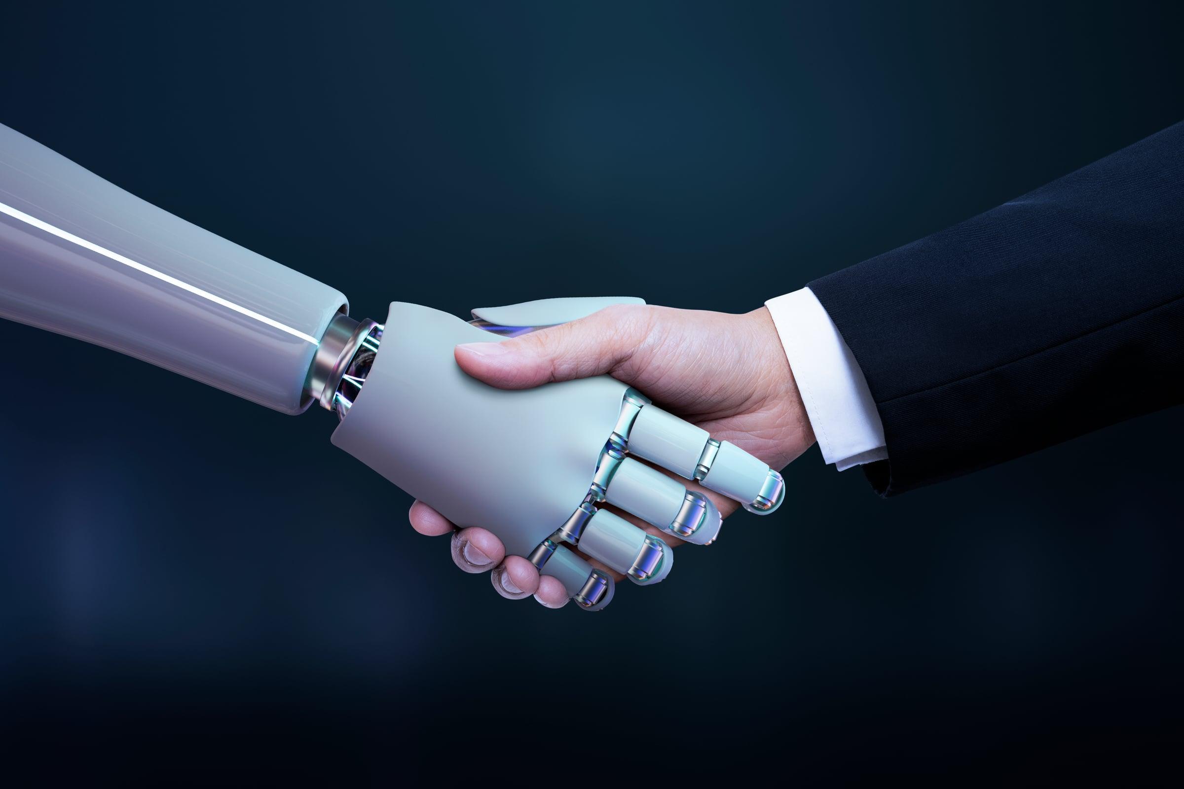 Business hand and robot handshake representing AI partnership