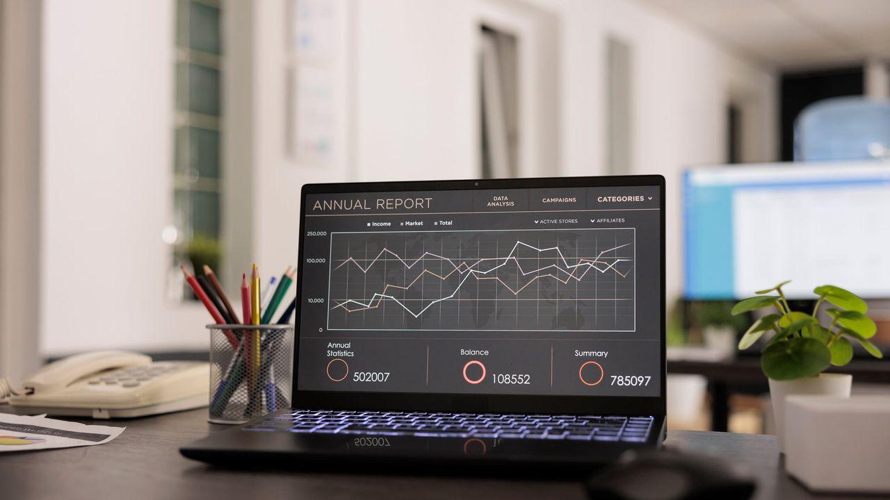 Workplace with annual data report on portable computer